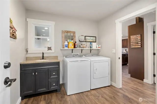 Nice laundry space with utility sink is just off of the 2 car attached garage. Washer & Dryer stay.