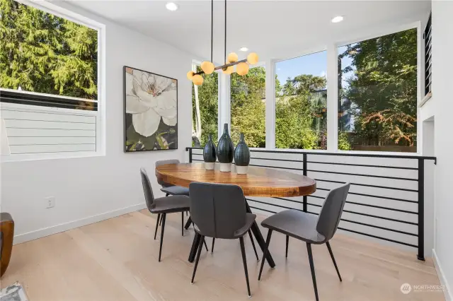 Enjoy meals in this light-filled dining space that perfectly frames serene greenery outside.