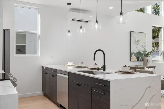 The kitchen offers a bright and open space with a large waterfall island.