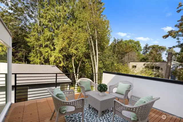 Enjoy serene views from the rooftop patio, surrounded by lush greenery, perfect for outdoor relaxation and entertaining.