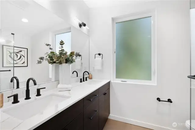 Bright and airy bathroom with double vanity and sleek, modern design.