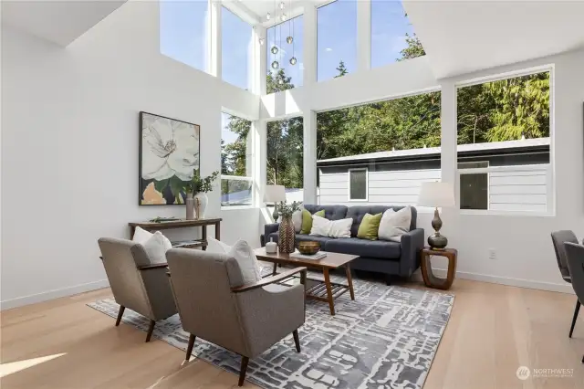 Bright and open living room with soaring ceilings and large windows, perfect for natural light and views.