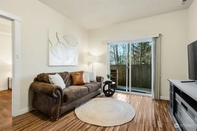 Apartment downstairs with sitting area, sliders to outside and up side stairs to front of home.