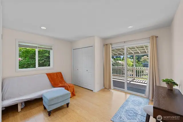 Secondary bedroom is spacious and leads to back deck