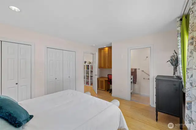 Another view of primary bedroom with  double closets, brand new half bath and built in hickory desk area