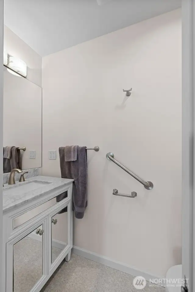 Custom half bathroom attached to primary. Only the best materials used in every space of this home