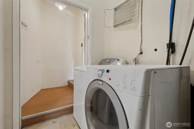 Laundry area on the original side with a door leading to the back yard