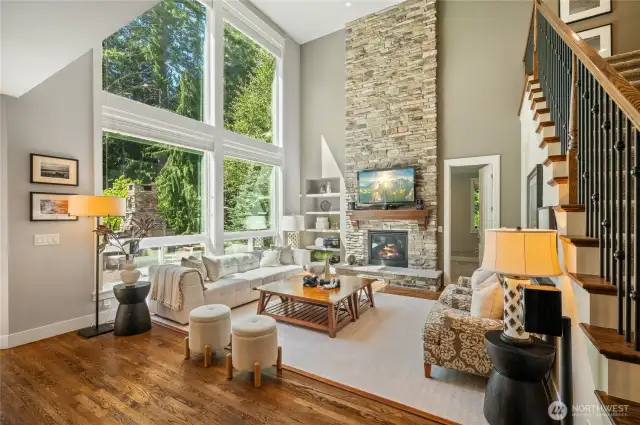 Floor-to-ceiling stone fireplace as the living room centerpiece.