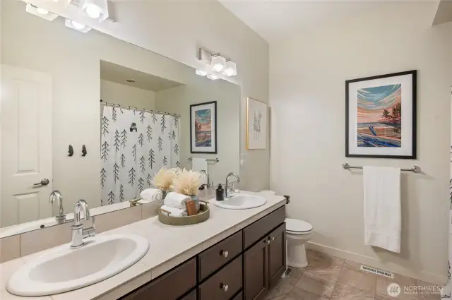 Full bath with tub/shower combo.