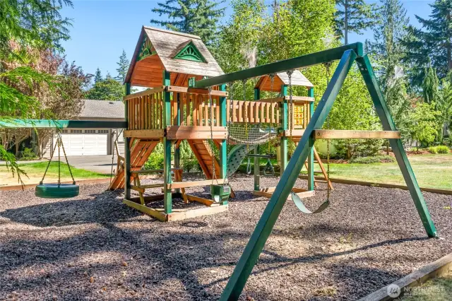 Play structure tucked into the park-like grounds.