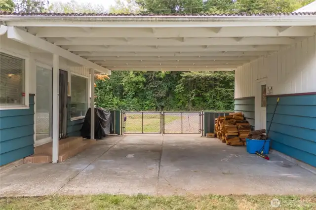 Covered breezeway between garage and house. Sliders opens to living room on the left