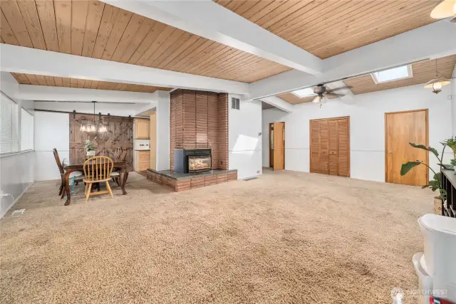 Large, bright living room with beautiful wood ceilings