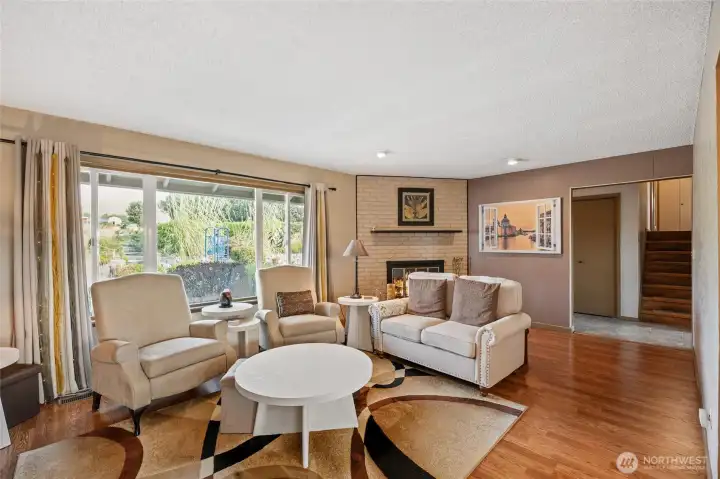 Lots of light and wood burning fireplace with brick surround