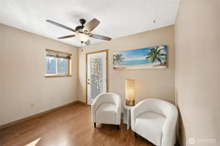 Downstairs sitting room/den. Door leads to pool area