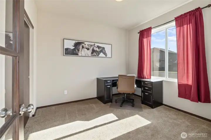 Whether you need an office with a view or a cozy spot for guests, this main floor bedroom has you covered—with a 3/4  bath just steps away.