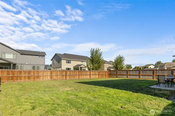 A large, flat, partially fenced yard with a  concrete patio right off the kitchen— ready for games, gardens, or gatherings. Bonus: irrigation system keeps things green (just  $45.50/month, April–October)