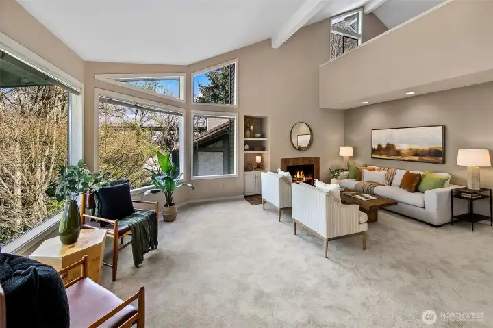 Vaulted ceilings. Two bedrooms on the main floor and a primary suite upstairs.  *Photo is from when the condo was staged.