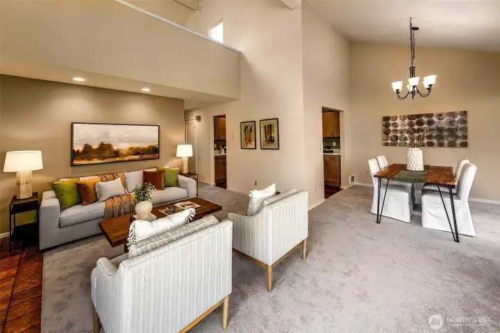 Vaulted ceilings. Two bedrooms on the main floor and a primary suite upstairs.  *Photo is from when the condo was staged.