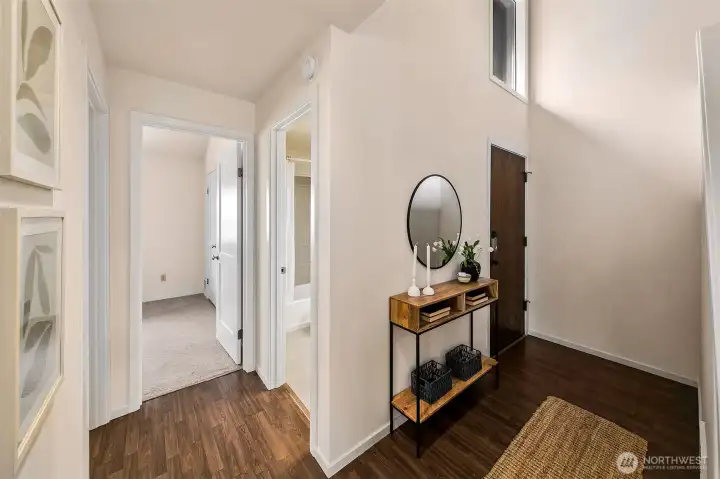 Entry, two bedrooms one bath and the laundry room are on this main level. It's nice to have an entry to kick off shoes and receive guests.  *Photo is from when the condo was staged.
