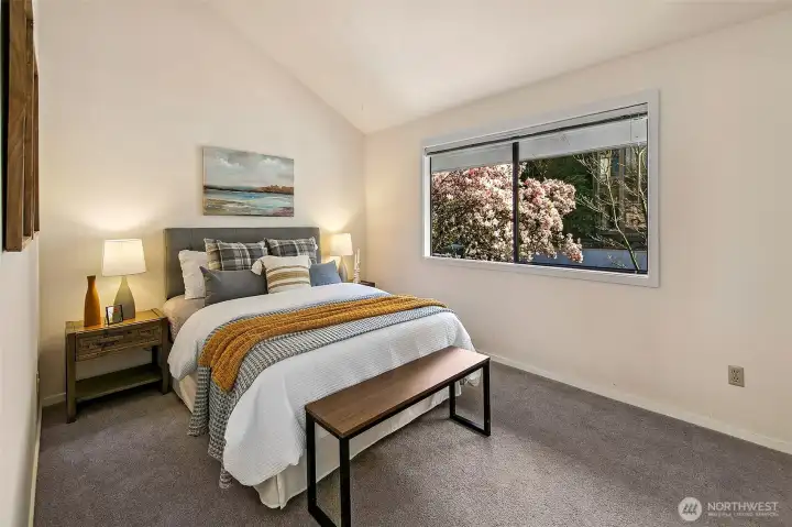 One of two bedrooms on the main floor. This one has vaulted ceilings.  *Photo is from when the condo was staged.