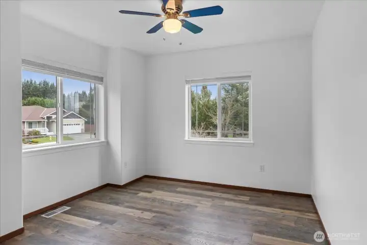 Fourth bedroom upstairs with ceiling fan.