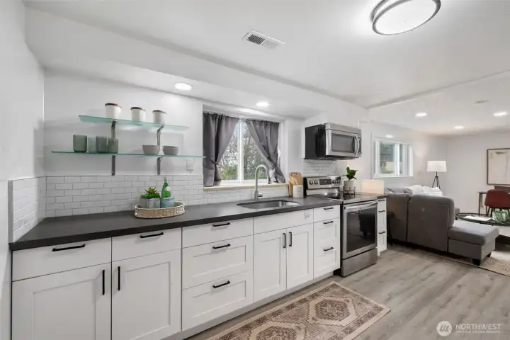 Lower level has an updated and functioning kitchen; there is an exterior door side entrance to this level.