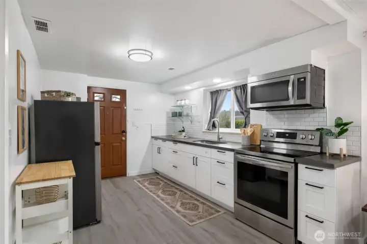 Lower level has an updated and functioning kitchen; there is an exterior door side entrance to this level.