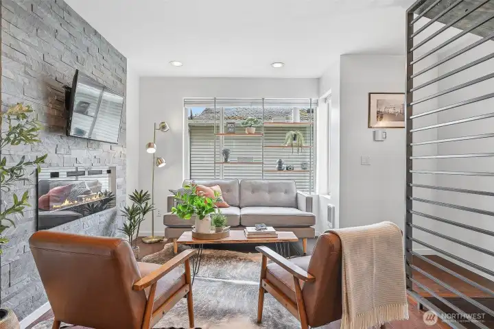 Engineered hardwood floors, industrial chic accents, a centerpiece fireplace - all accentuated by plentiful natural light pouring in.