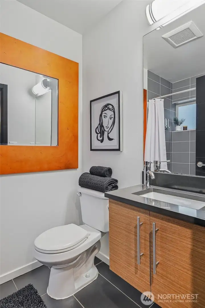 Full bathroom on the lower level, adjacent to the bedroom.