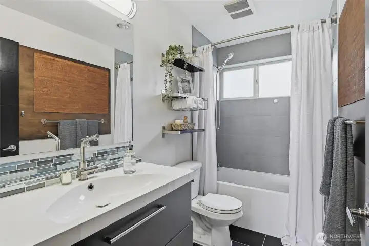 Stylish full ensuite bathroom off of the upstairs primary.