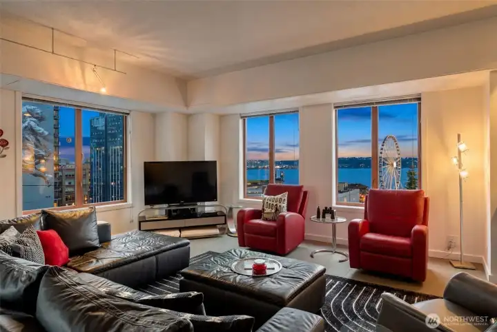 Light-filled corner living room with expansive windows and open entertaining space.