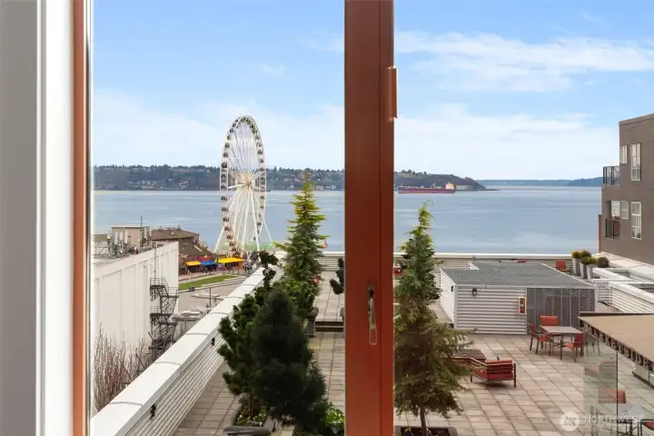 Large windows frame the waterfront while filling the home with natural light.