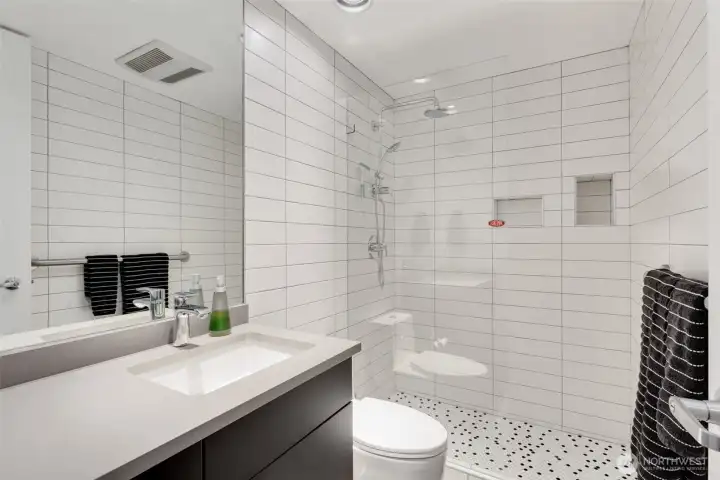 Just off the entrance is this 3/4 bath with walk-in shower. Both bathrooms were updated in 2018 with new cabinets, floors, countertops, full-tiled walls, toilets, faucets, etc.