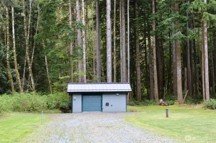 Outbuilding has storage space plus 1/2 bath.