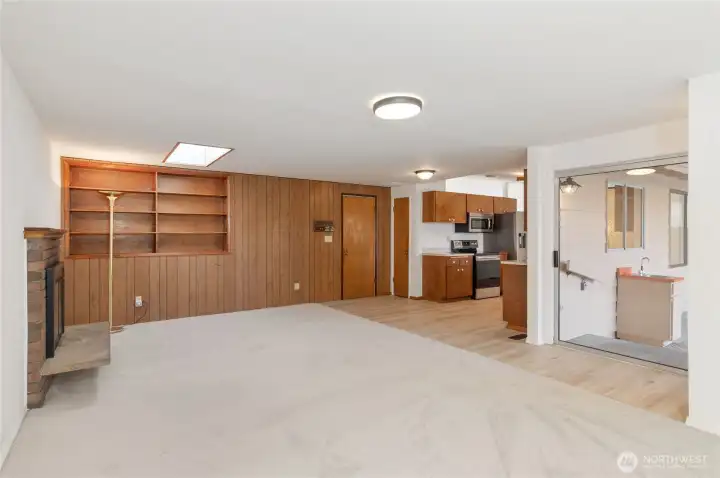 family with slider, garage door, bookshelves, kitchen