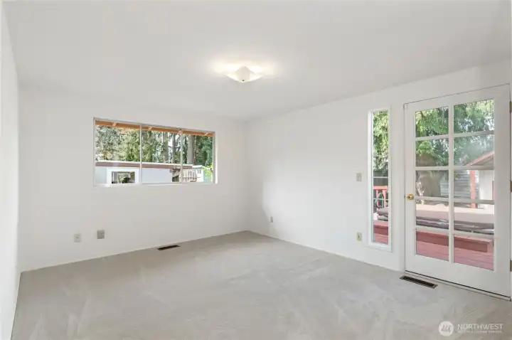 primary bedroom showing french door to deck and hot tub