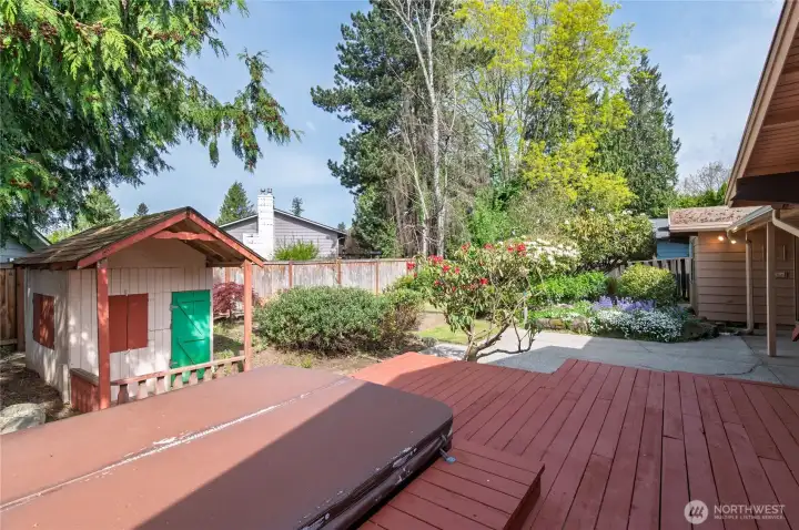 back garden showing deck, patio, hot tub and playhouse