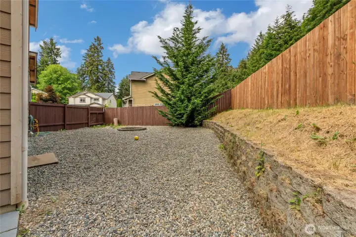 fenced backyard with firepit
