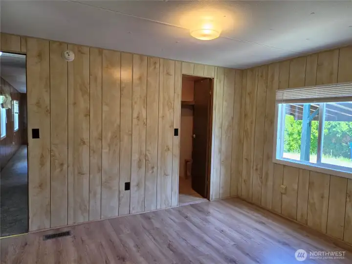 Primary bedroom with updated vinyl flooring