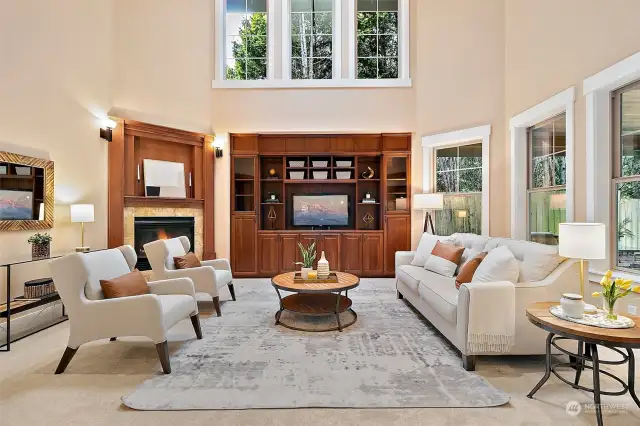 Family room with 2-story vaulted ceilings soaring windows and gas fireplace