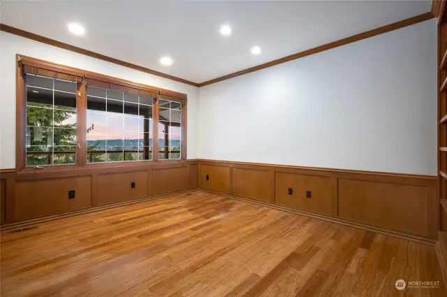 Big space! Den/office has a wall of built-in cabinets.