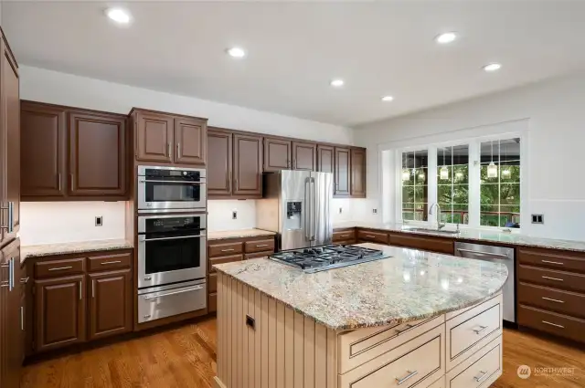 Large island, granite and gas cooktop.  Double pantry is to the left and has pull-out drawers.