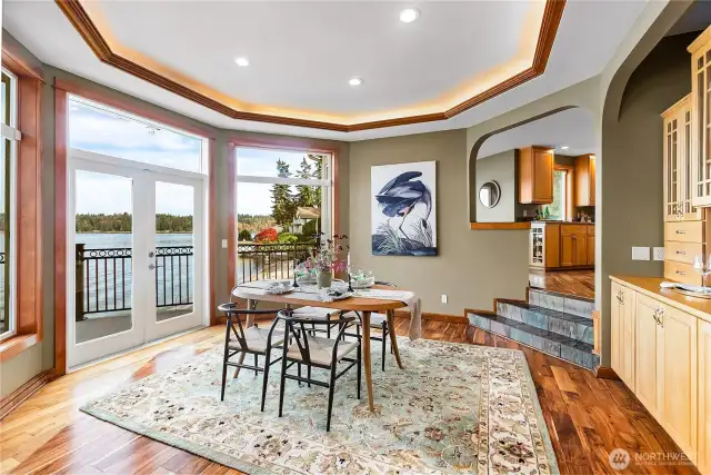 Dining room with built in China cabinet coved ceiling and double doors to the huge front deck.