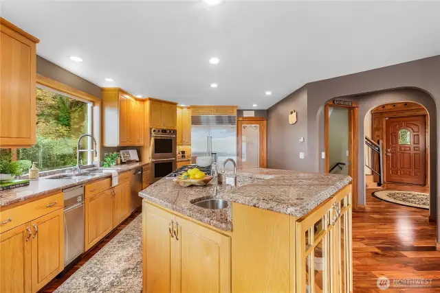 Kitchen with oversized island and built-ins, Subzero fridge freezer, double ovens, trash compactor and dishwasher