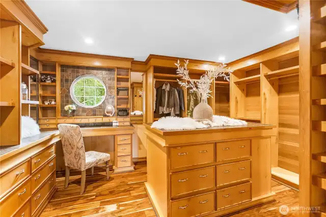 To die for primary closet with everything built in, drawers, jewelry boxes, shoe rack and shelves and hanging.