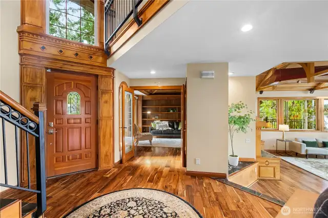 Another view of the entry and den with the living room on the right and the Wineweery Canoe custom made hanging from the beams in the ceiling of the living room.