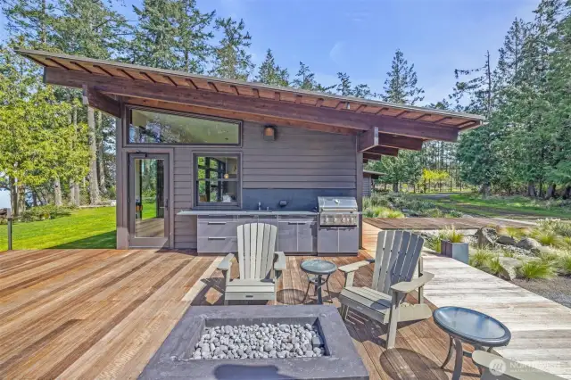 Outdoor kitchen, with a gas fire pit for entertaining.