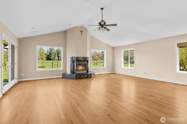 Light and bright family room/great room with vaulted ceilings, fireplace and French door access to patio and spacious backyard.