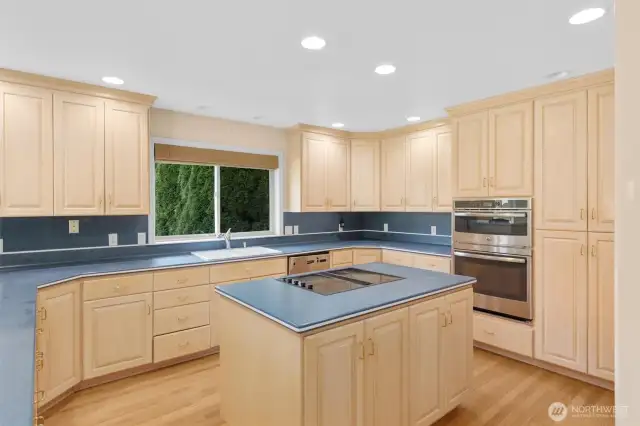 Large kitchen with center island, double ovens, built-in fridge and an impressive amount of storage!