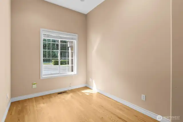 Home office conveniently located off entry and kitchen with hardwood floors.